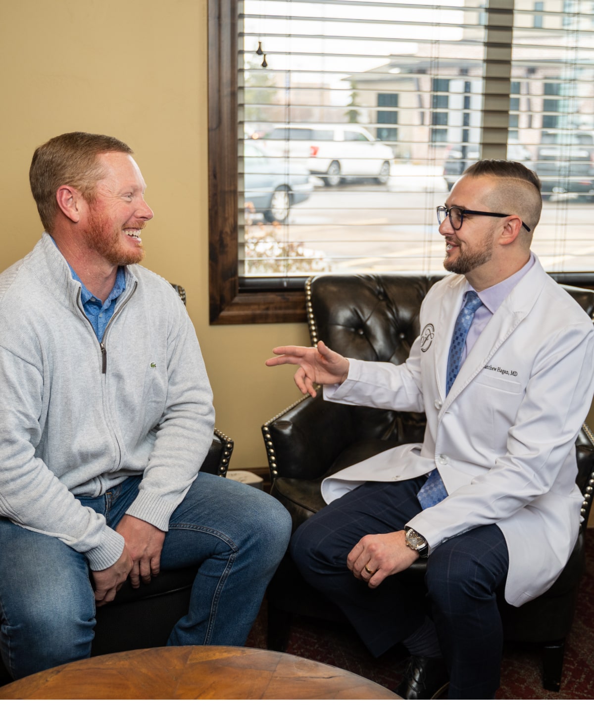 Reading Male Plastic Surgeon Dr. Matthew Hagan consulting with patient